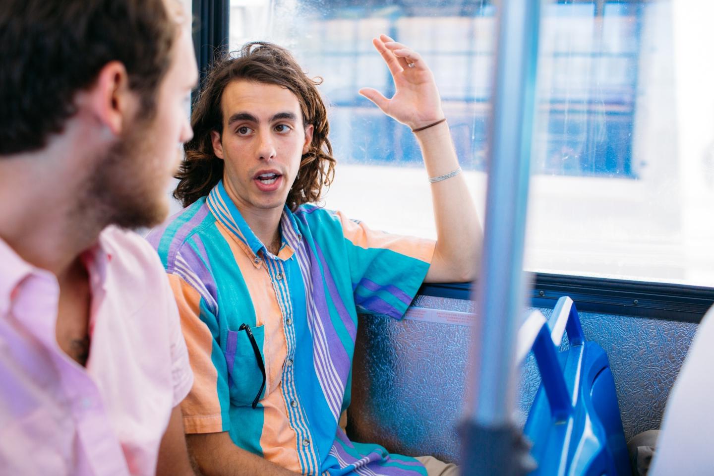Two students talking on a bus