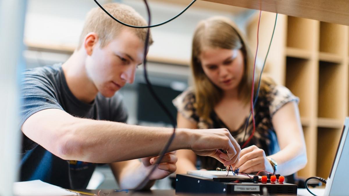 Up close up image of students building electronics